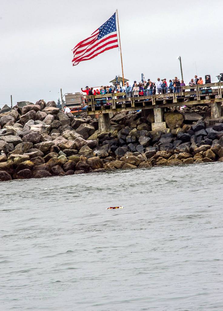 Photo courtesy Brandy Evans                                 A crowd gathered at the Fishermen&rsquo;s Memorial in Westport to witness the ceremony. The wreath is at center, on the water.