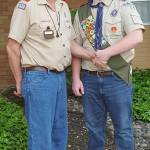 Photo courtesy Rick Strom                                Justin Gay shakes hands with Scoutmaster Alvin Gay, his grandfather.