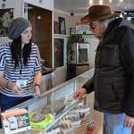 Jessica Leppala, left, helps customer Dave Watters on Monday at Evergreen Cannabis in Blaine. (Philip A. Dwyer/Bellingham Herald)