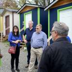 DAN HAMMOCK THE DAILY WORLD                                Sharon Lee, Director of the Low Income Housing Institute, introduced a group from Grays Harbor to residents of a tiny house village in Seattle. Facing the camera from left are Lee, Tim Quigg and Grays Harbor County Commissioner Randy Ross.