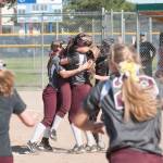 (Brendan Carl | The Daily World) Montesano&rsquo;s Samantha Stanfield lifts up Hannah Quinn as the Bulldogs celebrate winning the state 1A softball title on Saturday.