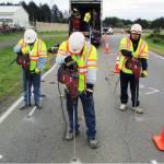 Photo by Scott D. Johnston: Workers from Uretek USA drilled holes in the pavement on Canal Drive in Ocean Shores Thursday as part of preparing for a test of a polyurethane injection process for roadbed stabilization and pavement lifting. The result for the big dip on Canal was that &ldquo;ride quality is significantly better, but still not perfect,&rdquo; Ocean Shores Public Works Director Nick Bird said.