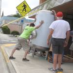 Kat Bryant | The Daily World                                The brite tank (used for carbonation) had to be tilted onto its side to fit through the doors for installation. On hand to help, from left, were Jim Heikel, Brad Jones and Bob Paylor, with Hoquiam Brewing partner Patrick Durney at right.