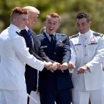 Ryan James Carpenter, left, of Aurora, Colorado, poses for a photograph with President Donald Trump and two others after Trump gave Carpenter his commission at the United States Coast Guard Academy&rsquo;s 136th commencement exercises Wednesday, May 17, 2017 in New London, Conn. (Cloe Piosson/Hartford Courant/TNS)