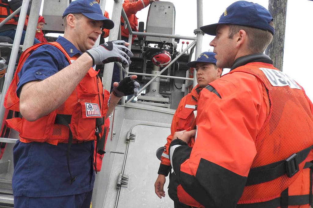 CWO Cheston Evans gives instructions to Nicholas Samano and Joe Dickson before getting underway.
