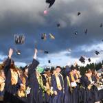 Aberdeen High graduates toss their mortar boards into the air to celebrate the end of their high school careers Friday night at Stewart Field. (Photo by Matthew Coyle)
