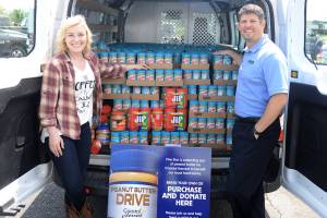 DAN HAMMOCK | THE DAILY WORLD                                Thousands of pounds of peanut butter were collected during Five Star Ford&rsquo;s month long Ford Focus on Hunger peanut butter drive. On the left is Coastal Harvest Executive Director Angela Burton, on the right is Five Star Ford General Manager Damon Gleason.
