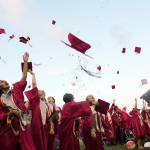 (Brendan Carl | The Daily World) Hoquiam High School&rsquo;s class of 2017 celebrates the end of their high school careers with the traditional toss of mortar boards Friday night at Olympic Stadium in Hoquiam.e Daily World)