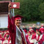 (Brendan Carl | The Daily World) Ryan Espedal proudly holds up his diploma at Olympic Stadium on Friday night.