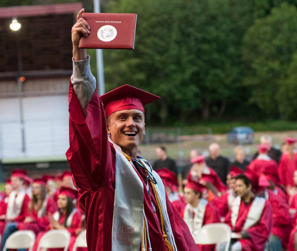 (Brendan Carl | The Daily World) Ryan Espedal proudly holds up his diploma at Olympic Stadium on Friday night.