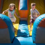(File photo)                                Kadalynn Richardson and Emmett Johnson run out of a bounce house at the 2015 Splash Festival in Aberdeen.