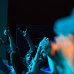 Audience members hold up horn hands for Leon Virgil Bowers as he and his band play at the D&R Theatre at the 2015 Kurt Cobain Days.
