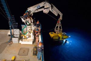 Ocean Exploration Trust photo                                Part of the crew of the research vessel Nautilus prepare to lower one of the ship&rsquo;s two remote controlled vehicles for nighttime research. Live video of the Quinault Canyon research will be available at www.nautiluslive.org.
