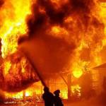 (Photo courtesy Shannon Olson) Firefighters douse a July 4 blaze at the old Oakville hardware store. The blaze reduced three buildings, including the hardware store, to rubble.