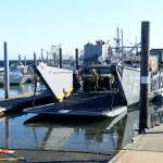 DAN HAMMOCK | THE DAILY WORLD                                The first vehicle to depart the landing vessel at the Westport Marina Tuesday morning was this armored Army Humvee. It was followed by an ambulance, and aid vehicle and a front end loader.