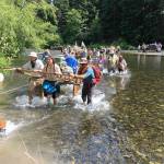 Photos by KayLynn Larsen                                ABOVE: Kayleigh Taylor, Joseph Johnson and Ryan Farrer pull a handcart through the Yakima River.                                BELOW: Nick Farrer leads a family through the Yakima River.