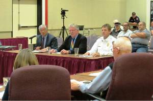 Scott D. Johnston photo Peter Moy and John Montanero of Financial Consulting Solutions Group and Ocean Shores Fire Chief David Bathke address the Ocean Shores City Council on Aug. 14 about a preliminary draft of a new ambulance utility rate study.