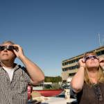 (Doug Barker | The Daily World) Rich and Laurie Wyatt of Montesano watched the eclipse from the parking lot at Community Hospital, where Laurie works. She came out for a quick look just before the eclipse was at its fullest. Glasses were scarce, but they shared theirs with others.