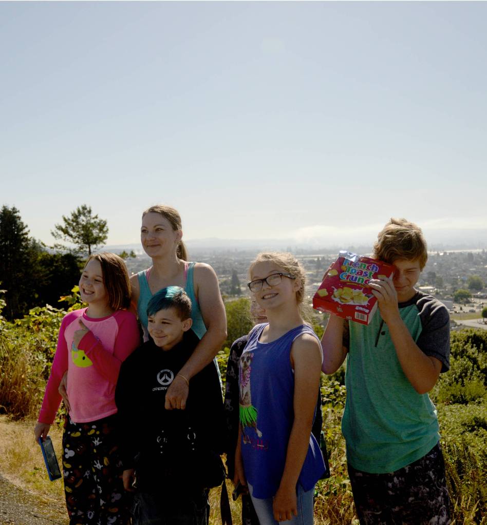 (Doug Barker | The Daily World) From left, Ella Horton, Amanda Dee, Alex Dee (black sweatshirt), Myleigh Gramson and Kain Horton, pose for posterity as the eclipse was waning Monday morning at Community Hospital. Barely visible behind Myleigh is Ary Jenkins.