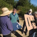 (Kat Bryant | The Daily World)                                This foursome set up a pinhole viewer with a birding scope to view the eclipse on Radar Ridge.