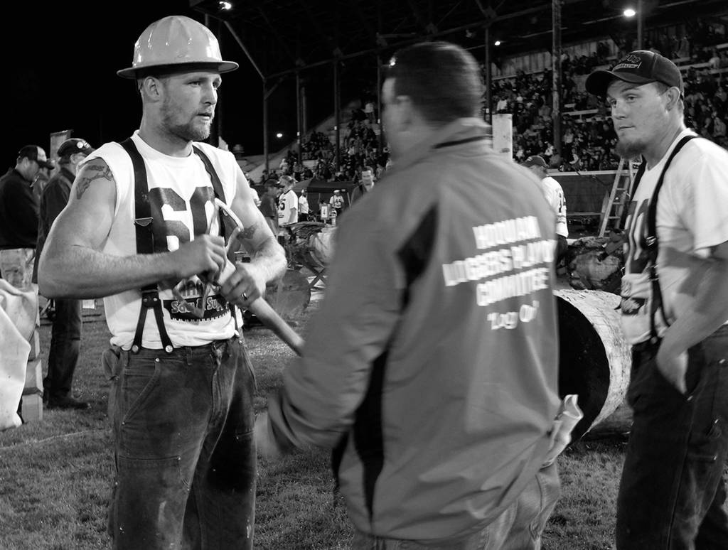 (Kat Bryant | The Daily World) Johnny Boggs, left, and Cody Stearns listen to instructions from Loggers Playday board member Josh Lennox on Saturday. Boggs was the 2017 local high-point logger.