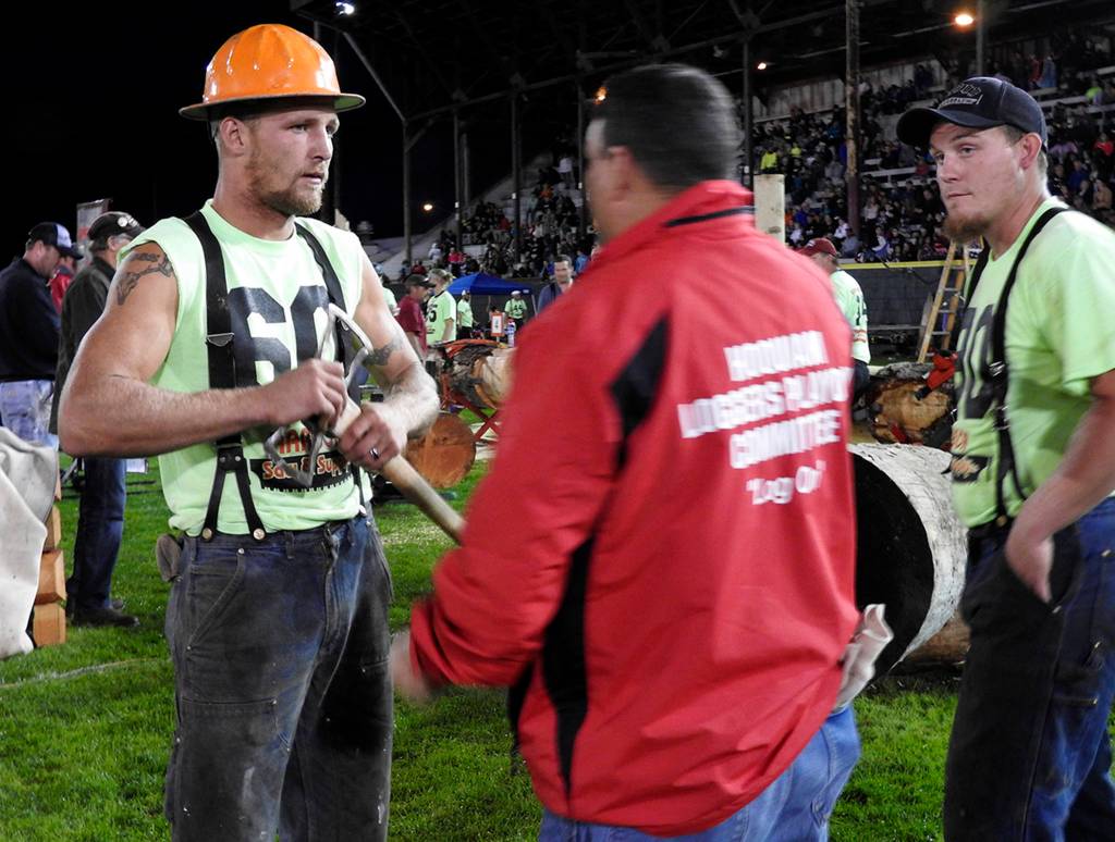 (Kat Bryant | The Daily World) Johnny Boggs, left, and Cody Stearns listen to instructions from Loggers Playday board member Josh Lennox on Saturday. Boggs was the 2017 local high-point logger.