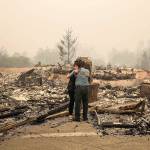 Penny Wright weeps with husband Edward after arriving at their Fountaingrove home of 10 years to find it was completely destroyed in the the Monday morning inferno in Santa Rosa, Calif. (Brian van der Brug/Los Angeles Times)