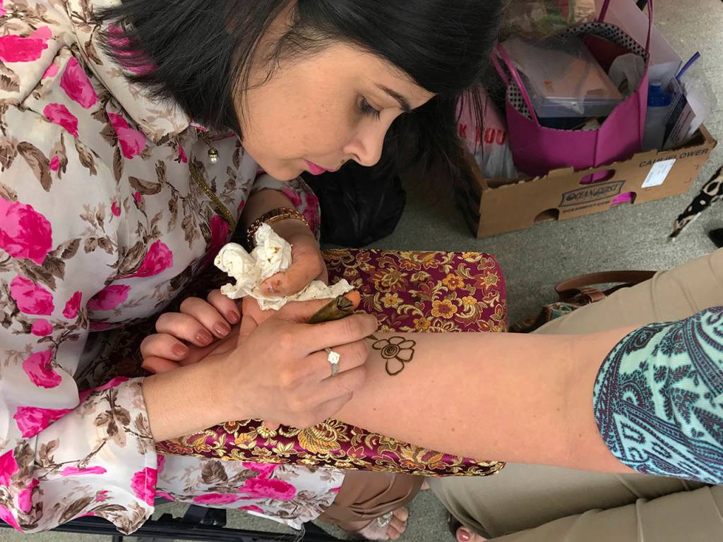 Neha Babuta applies a henna design during the Kent International Festival in June. Henna is a plant used to create a reddish-brown dye in many South Asian, Middle Eastern and Northern African cultures. Mehandi (the art of applying henna to hands and feet) is usually done for celebrations and rites of passage.