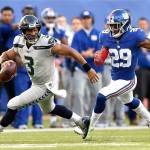Seattle quarterback Russell Wilson tries to evade the tackle of New York safety Nat Behre at MetLife Stadium in East Rutherford, New Jersey, on Sunday. (Brooks Von Arx | ZUMA Wire)