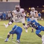 Montesano running back Carson Klinger hurdles an Elma defender during a 47-yard run on Friday night at Davis Field in Elma. The Bulldogs won the game, 51-0. (Brendan Carl Photography)