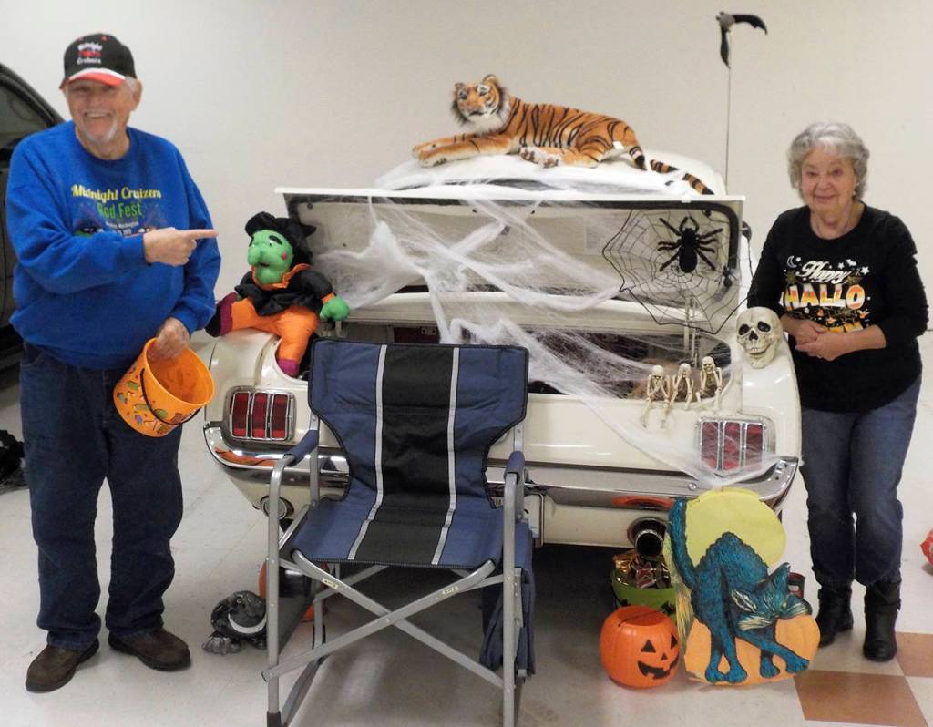 Lew and Matzie Key decorated their Mustang with webbing, pumpkins, and a tiger on the roof.