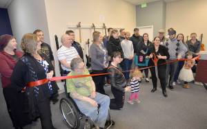 DAN HAMMOCK | THE DAILY WORLD                                The Garage: A Music and Arts Center had its official ribbon-cutting Monday at the Shoppes at Riverside. Holding the scissors is Kelly Durham, the organizations chief operations officer. To her immediate left is Chief Executive Officer JR Lakey.
