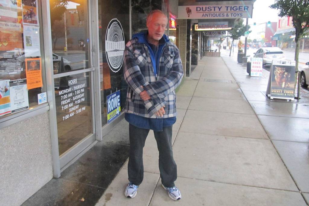 Ron B. White, 55, stands outside the Tinderbox in Aberdeen. He is suspected of starting two fires at a house on Thorton Street. (Courtesy Aberdeen Police)