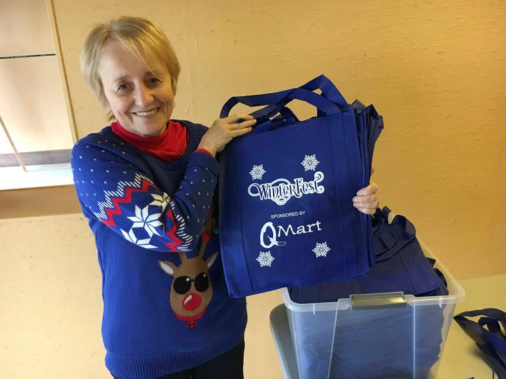 The first 200 visitors to the Winterfest Market on Friday will receive a free commemorative shopping bag, shown by event co-organizer Bobbi McCracken. (Kat Bryant | The Daily World)