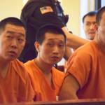 (Todd Bennington | Twin Harbors Newspaper Group) Three men await arraignment Monday morning on charges stemming from the takedown of a major marijuana grow operation. In all, about a dozen people were arraigned in the case. Many averted their faces in order to avoid having their photo taken.