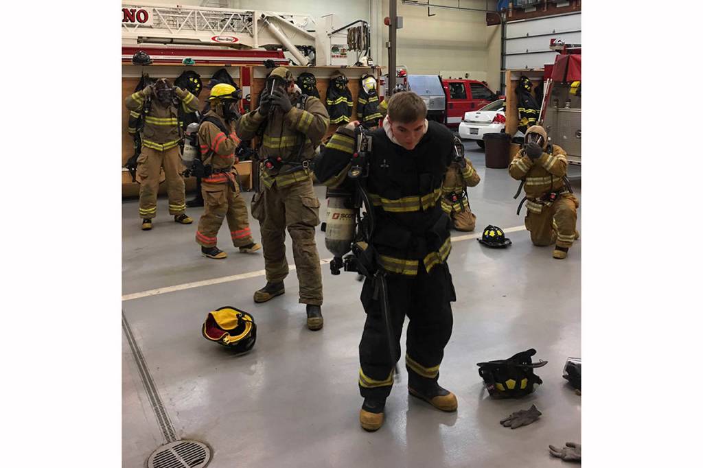 (Todd Bennington | Twin Harbors Newspaper Group)                                Fire cadet program students practice donning their protective equipment at the Montesano Fire Department on Dec. 2. At front is Monte senior Connor Parkinson.