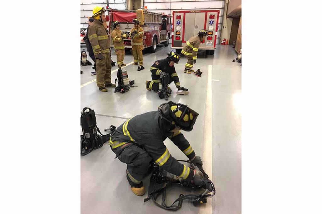 (Todd Bennington | Twin Harbors Newspaper Group)                                Fire cadet program students practice donning protective equipment at the Montesano Fire Department on Dec. 2.