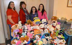 DAN HAMMOCK | THE DAILY WORLD                                Lilly Delahanty, the official Teddy Bear Officer for the Montesano VFW Auxiliary, shows off the stuffed toys she collected all year before donating them to the Childrens Administration Office in Aberdeen Friday. Pictured from left are VFW Auxiliary President T.J. Glick, Auxiliary Secretary Diane Nillson, Lilly and her mom, Ciara Brough.