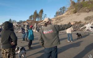 VAN ADAM DAVIS PHOTO                                Pacific County Drainage District Commission Chairman David Cottrell, sporting a Wash Away No More jacket, leads a tour of North Cove residents of the shoreline preservation efforts in the North Cove area New Years Day.