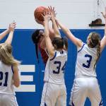 Elmas Jalyn Sackrider (3) and Kali Rambo (34) swarm Hoquiams Maddie German as she goes up for a shot during an Evergreen 1A League contest at Elma on Friday. (Brendan Carl Photography)