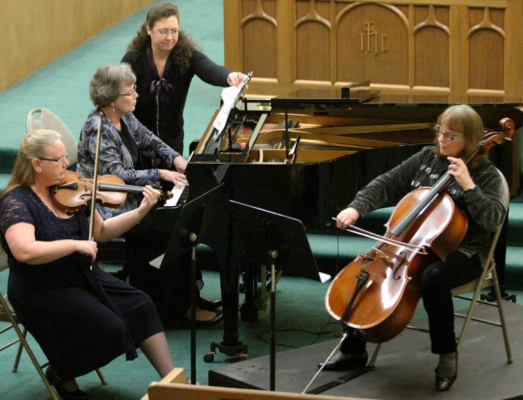Photo by Keith J. Krueger                                Violinist Karen Meikle, pianist Merry Jo Zimmer and cellist Jenny Leighton perform at Musicale 2013, aided by Kari Hasbrouck.