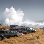 PATRICIA JOLLIMORE | FOR THE DAILY WORLD                                Waves tower over vehicles parked at Ocean Shores North Jetty.