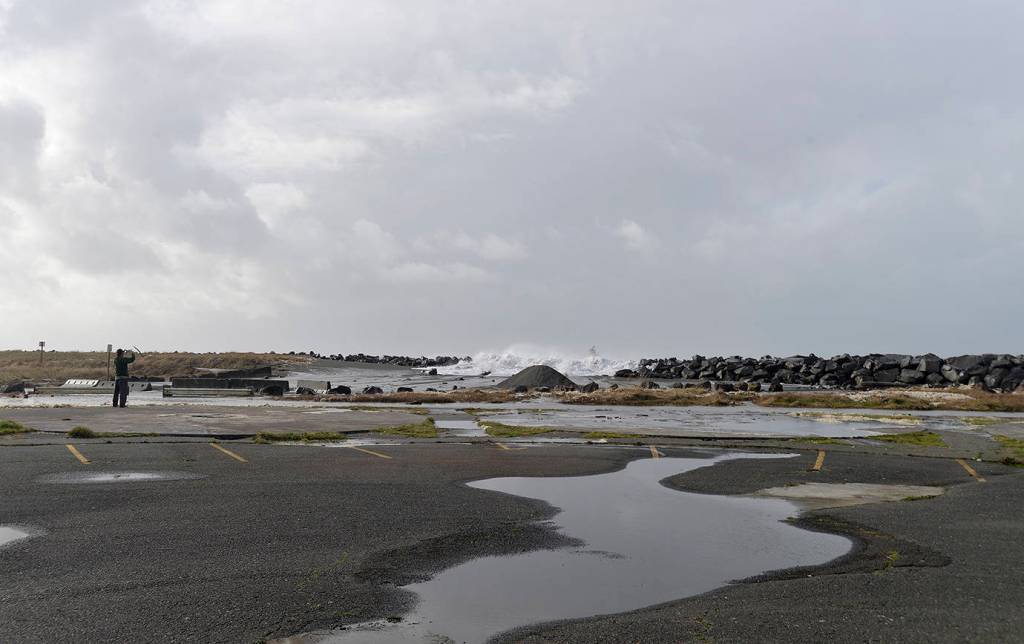 DAN HAMMOCK | THE DAILY WORLD                                 Waves tumble over the top of the Westport jetty, just west of the observation tower.