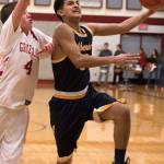 Aberdeens Javier Bojorge goes around Hoquiams Bryson Eccles for a layup on Monday. Bojorge finished with 19 points in the Bobcats 81-59 victory. (Brendan Carl Photography)