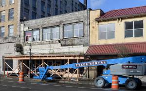 DAN HAMMOCK | THE DAILY WORLD                                Construction crews are working to remove the facade from the old Grays Harbor Beauty College building at 204 E. Wishkah St. The facade had deteriorated and pieces of it had been falling to the sidewalk below.