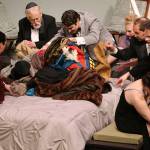 (Photo by Keith J. Krueger) Everyone scrambles to find Julias ringing cellphone in the stack of coats on the bed in the Driftwood Players production of Its Only a Play, opening Friday.