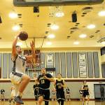 Tanner Nicklas hits a transition a layup against Forks in a district tournament game against Forks. Nicklas led the team with 16 points.