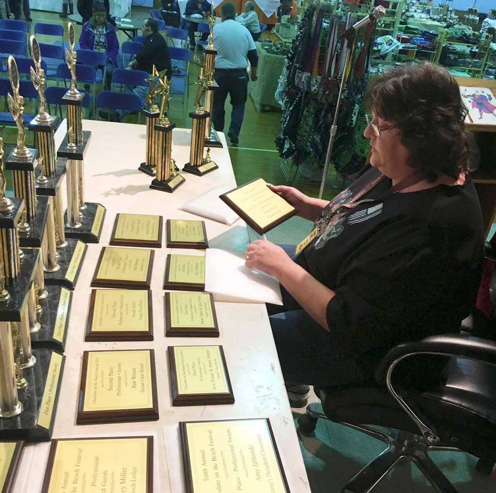 (Kat Bryant | The Daily World) Chocolate Lady Stephanie Allestad prepares the awards Sunday at the 2018 Chocolate on the Beach Festival in Pacific Beach.