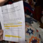 LOUIS KRAUSS THE DAILY WORLD A man displays his notice from the City of Aberdeen requiring him to move his trailer home from the camps along the Wishkah River.