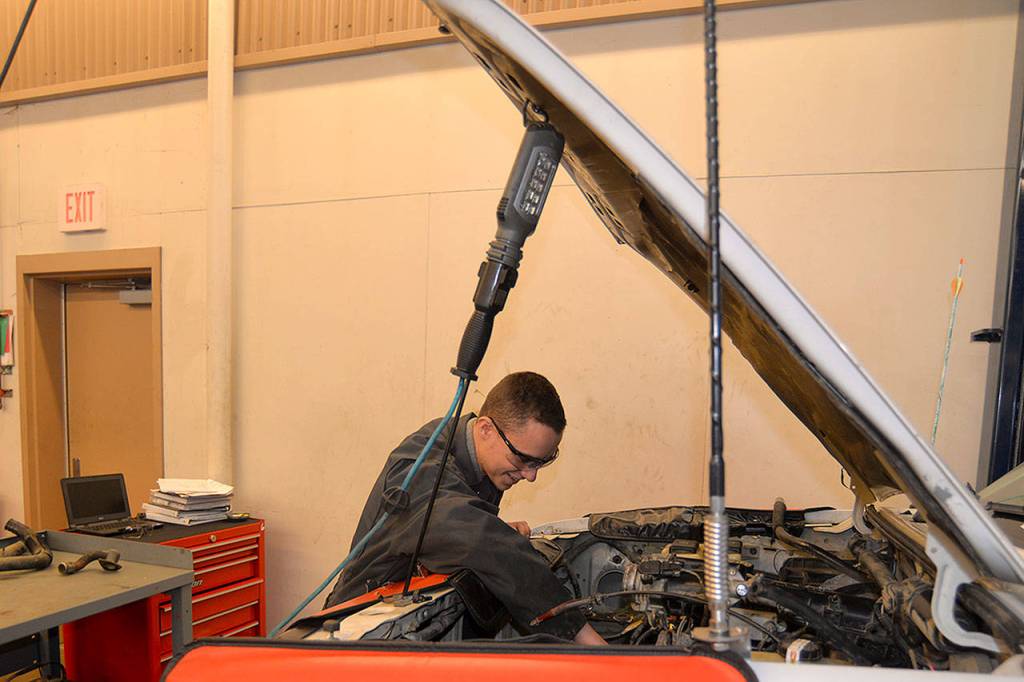 LOUIS KRAUSS | THE DAILY WORLD Tanner Jones, a senior at Aberdeen High School, fixes a truck being serviced at the schools auto shop.